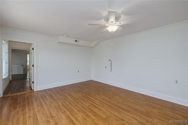 unfurnished room featuring light wood-type flooring, crown molding, ceiling fan, and visible vents
