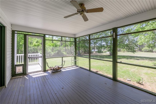 unfurnished sunroom with ceiling fan and a wealth of natural light
