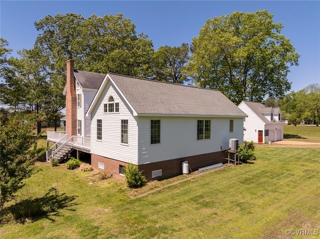 view of home's exterior featuring crawl space, a chimney, a lawn, stairway, and a shingled roof