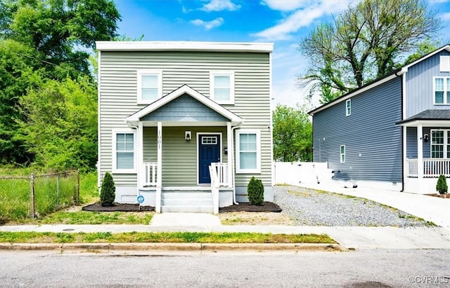 view of front of home featuring fence and a porch