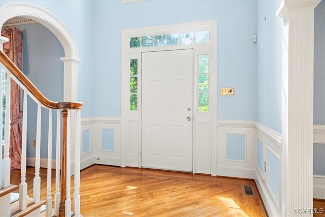 419 Dellbrooks Pl, Henrico, VA 23238 - foyer entrance with healthy amount of natural light, a decorative wall, light wood-style flooring, decorative columns, and a wainscoted wall