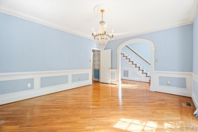 419 Dellbrooks Pl, Henrico, VA 23238 - unfurnished dining area with a chandelier, stairs, wood finished floors, arched walkways, and ornamental molding