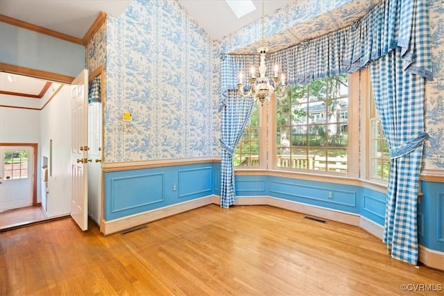 419 Dellbrooks Pl, Henrico, VA 23238 - unfurnished dining area featuring wood finished floors, a chandelier, wallpapered walls, wainscoting, and crown molding
