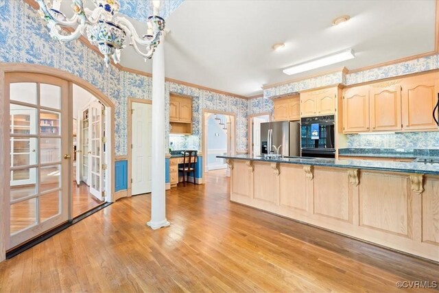 419 Dellbrooks Pl, Henrico, VA 23238 - kitchen with wallpapered walls, light brown cabinets, stainless steel fridge, a kitchen bar, and arched walkways