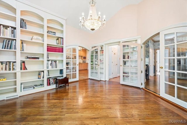 419 Dellbrooks Pl, Henrico, VA 23238 - unfurnished dining area with french doors, arched walkways, wood finished floors, a chandelier, and high vaulted ceiling
