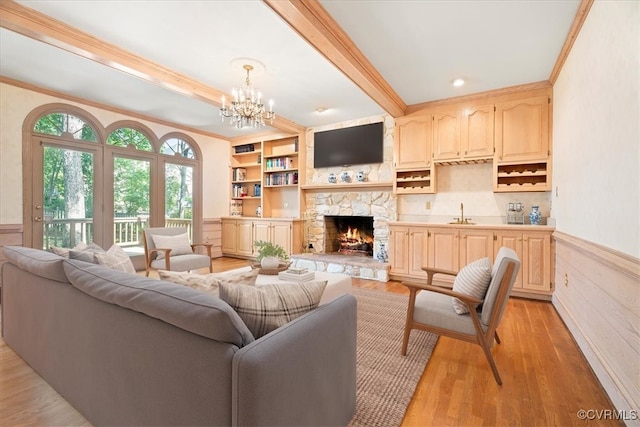 419 Dellbrooks Pl, Henrico, VA 23238 - living area with crown molding, a stone fireplace, a chandelier, light wood-style flooring, and wainscoting