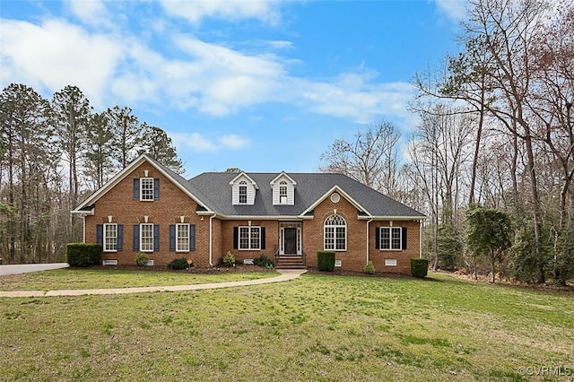view of front of house featuring brick siding and a front lawn