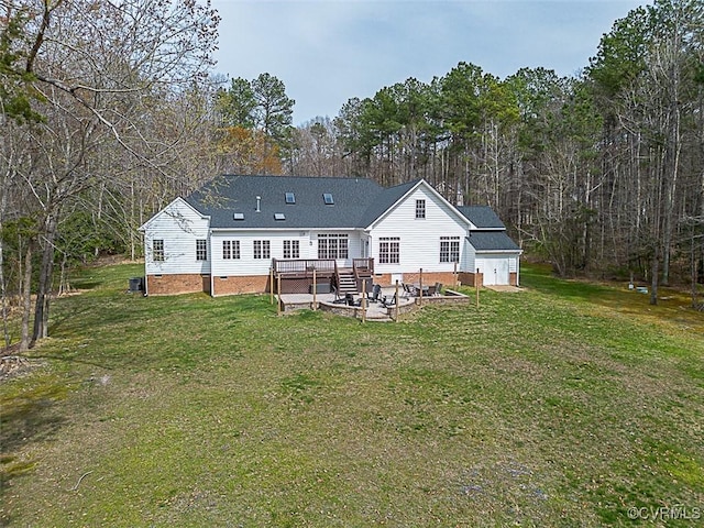 rear view of house with crawl space, a deck, a yard, and an outbuilding