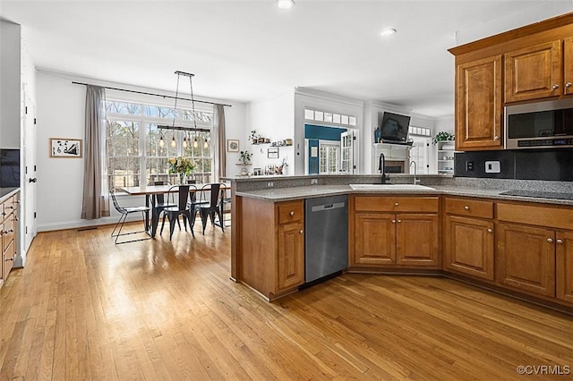 13325 Shore Lake Turn, Chesterfield, VA 23838 - kitchen with appliances with stainless steel finishes, brown cabinetry, light wood-type flooring, a peninsula, and recessed lighting