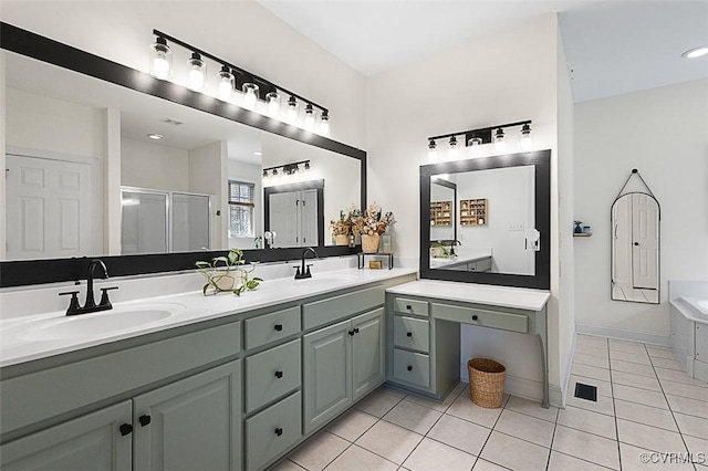 bathroom with a stall shower, tile patterned flooring, double vanity, and a sink