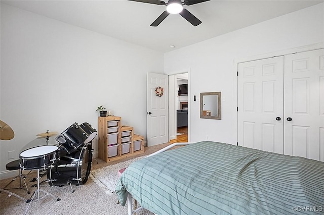 carpeted bedroom featuring a closet and ceiling fan