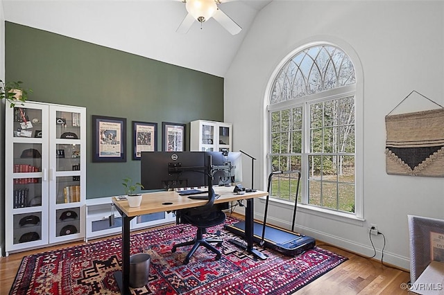 office featuring high vaulted ceiling, wood finished floors, a ceiling fan, and plenty of natural light