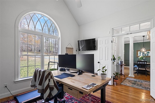 home office with high vaulted ceiling, ceiling fan, decorative columns, and wood finished floors