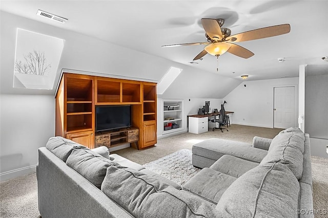living room featuring light colored carpet, visible vents, baseboards, vaulted ceiling, and a ceiling fan