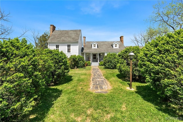 rear view of property with a lawn and a chimney