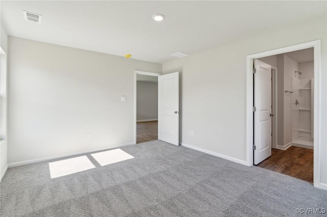 unfurnished bedroom with visible vents, carpet flooring, and baseboards