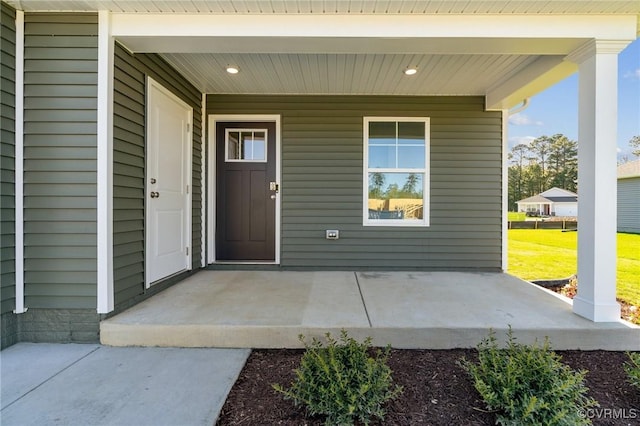 view of exterior entry with a porch