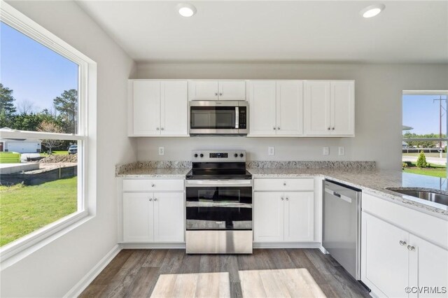 kitchen featuring white cabinets, stainless steel appliances, and recessed lighting