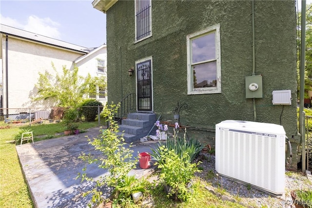 3220 Cliff Ave, Richmond, VA 23222 - rear view of property with cooling unit, stucco siding, and a patio