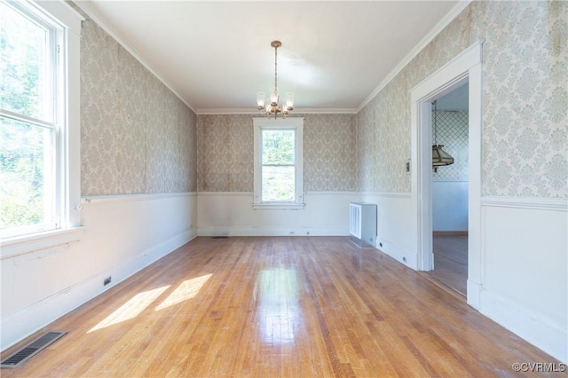 3220 Cliff Ave, Richmond, VA 23222 - unfurnished dining area with wood finished floors, a wainscoted wall, a chandelier, crown molding, and wallpapered walls