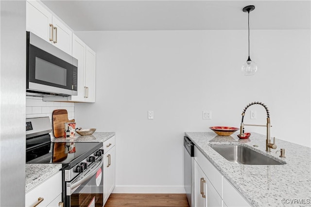 427 Harding St, Petersburg, VA 23803 - kitchen with a sink, baseboards, backsplash, light stone countertops, and appliances with stainless steel finishes