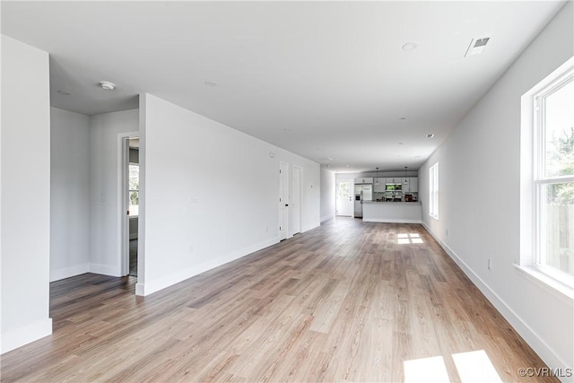 427 Harding St, Petersburg, VA 23803 - unfurnished living room with light wood-style floors, plenty of natural light, and visible vents
