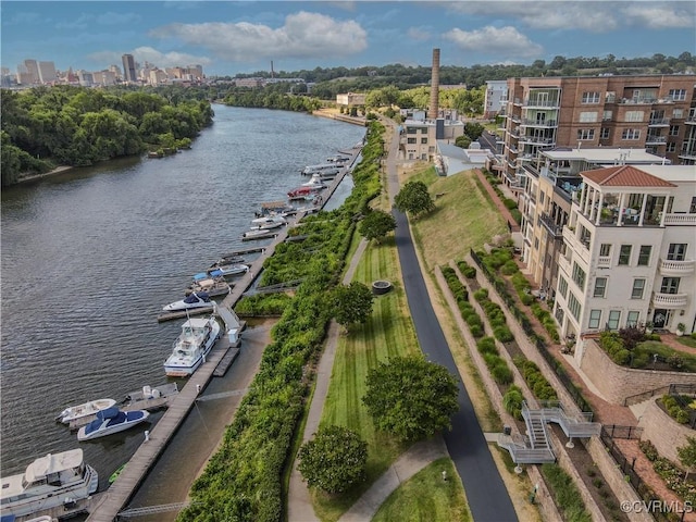 birds eye view of property with a water view and a view of city