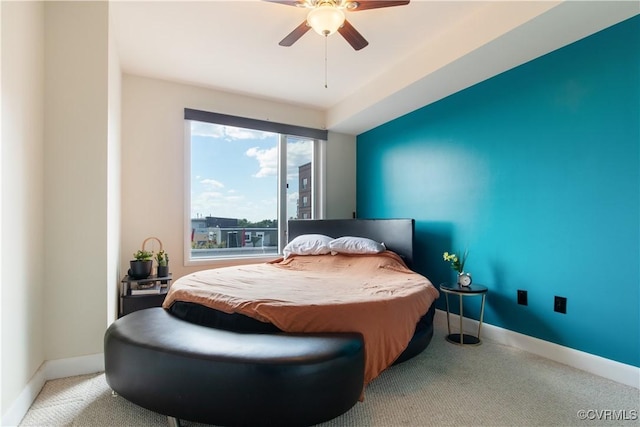carpeted bedroom with ceiling fan and baseboards