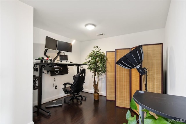 workout room with wood finished floors, visible vents, and baseboards
