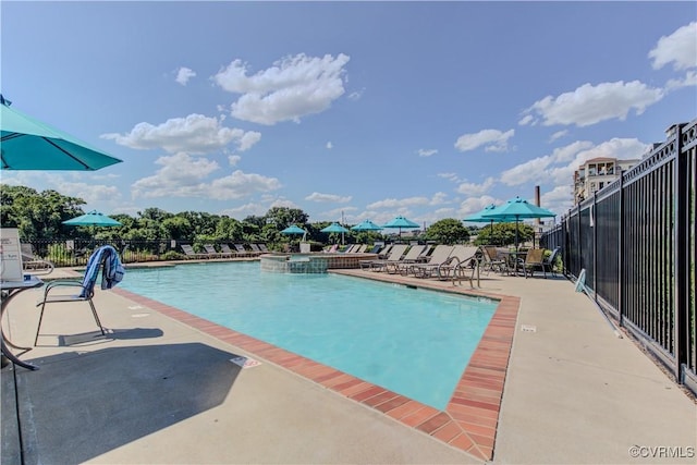 community pool featuring fence and a patio