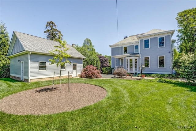 rear view of property featuring a yard