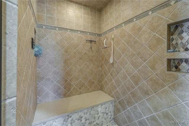 full bath featuring tiled shower
