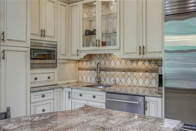 bar featuring a sink, built in appliances, and tasteful backsplash