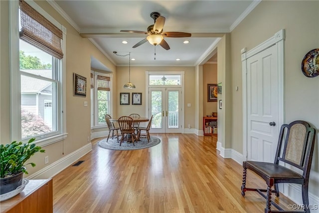 living area featuring baseboards, ceiling fan, french doors, and light wood-type flooring