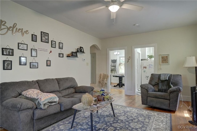 4821 W Seminary Ave, Richmond, VA 23227 - living area featuring a ceiling fan, arched walkways, wood finished floors, and baseboards