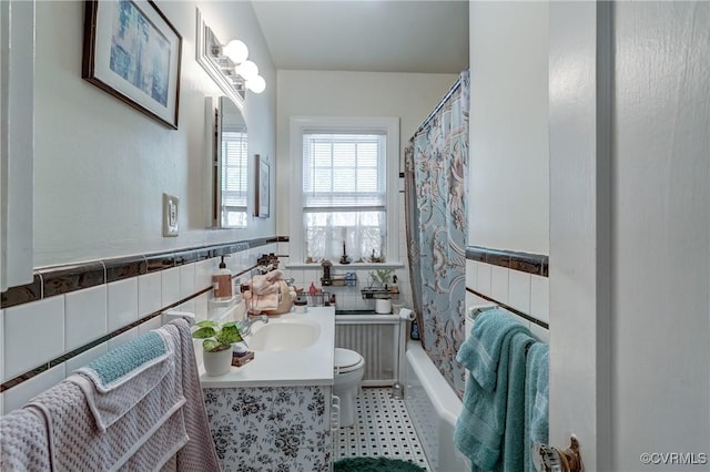 4821 W Seminary Ave, Richmond, VA 23227 - full bathroom with shower / tub combo, toilet, tile walls, vanity, and wainscoting