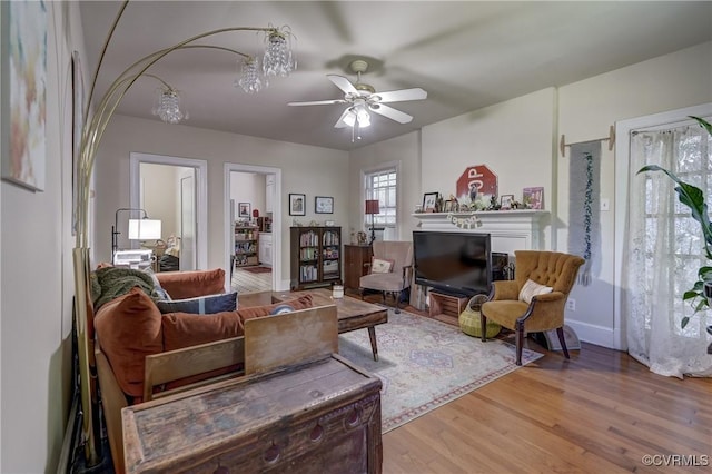 4821 W Seminary Ave, Richmond, VA 23227 - living area featuring baseboards, wood finished floors, a ceiling fan, and a glass covered fireplace