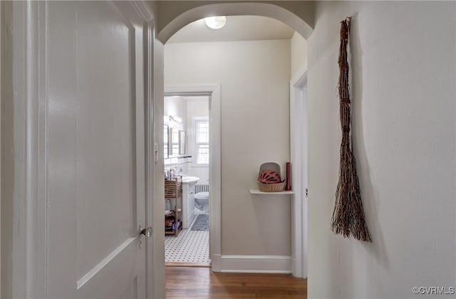 4821 W Seminary Ave, Richmond, VA 23227 - hallway with arched walkways, wood finished floors, and baseboards