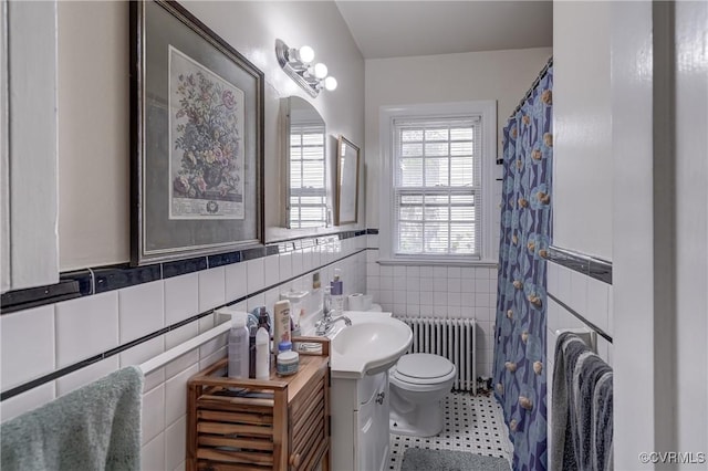 4821 W Seminary Ave, Richmond, VA 23227 - bathroom featuring radiator, toilet, tile walls, vanity, and tile patterned flooring