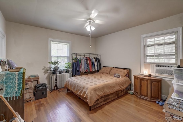 4821 W Seminary Ave, Richmond, VA 23227 - bedroom with radiator heating unit, wood finished floors, ceiling fan, and cooling unit