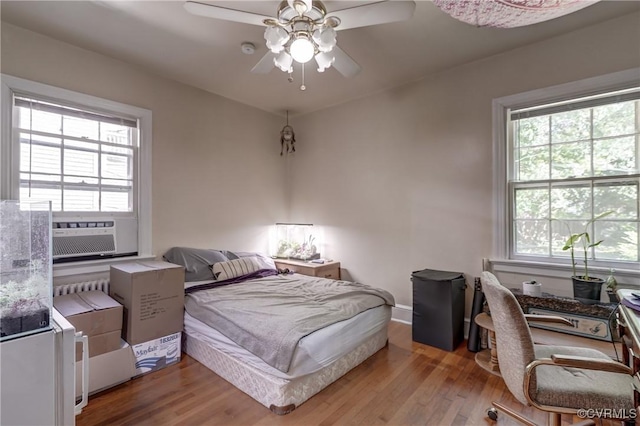4821 W Seminary Ave, Richmond, VA 23227 - bedroom with wood finished floors, cooling unit, and multiple windows