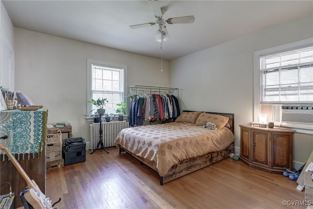 4821 W Seminary Ave, Richmond, VA 23227 - bedroom with cooling unit, a ceiling fan, radiator heating unit, and wood finished floors