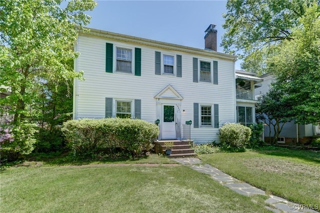 4821 W Seminary Ave, Richmond, VA 23227 - colonial-style house featuring a chimney, entry steps, a front lawn, and a balcony