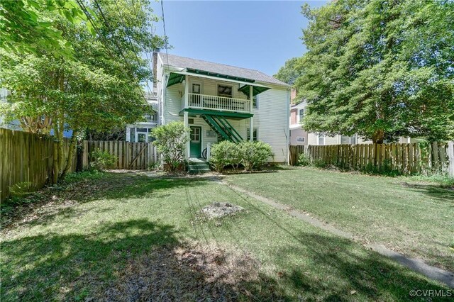 4821 W Seminary Ave, Richmond, VA 23227 - back of house with a lawn, a fenced backyard, and a balcony