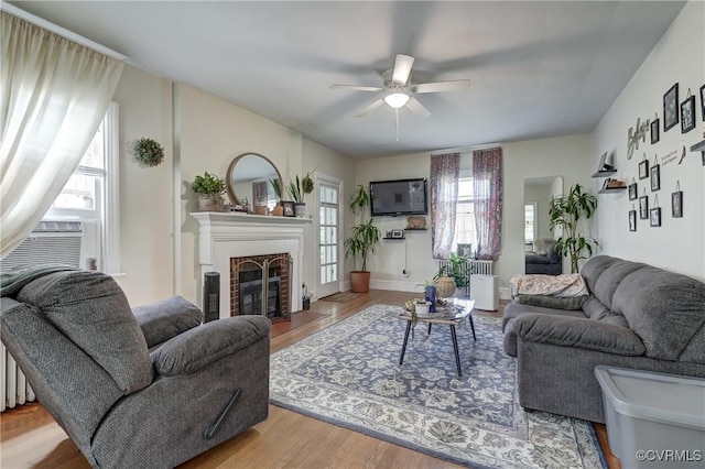 4821 W Seminary Ave, Richmond, VA 23227 - living room with a fireplace, ceiling fan, wood finished floors, and plenty of natural light