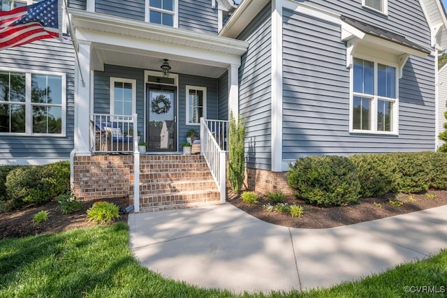 entrance to property featuring a porch