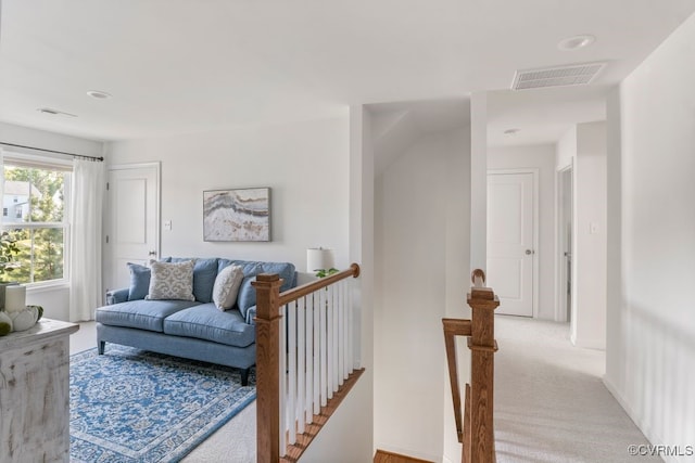 living room with visible vents and light carpet