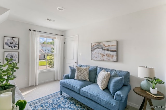living area with baseboards, carpet flooring, and visible vents
