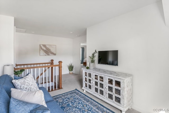 carpeted living area with baseboards