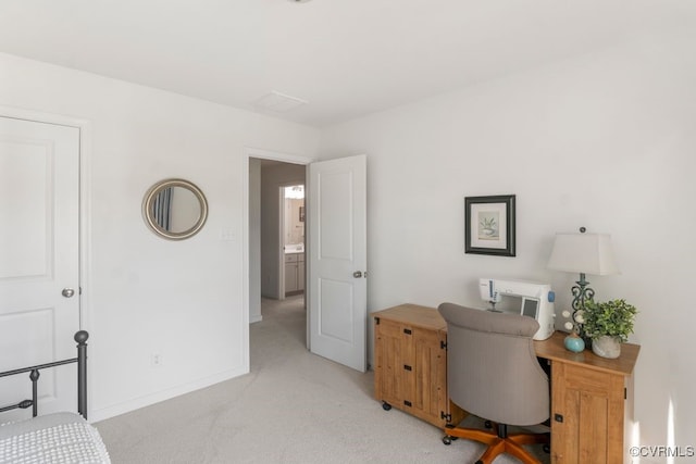home office with baseboards and light carpet